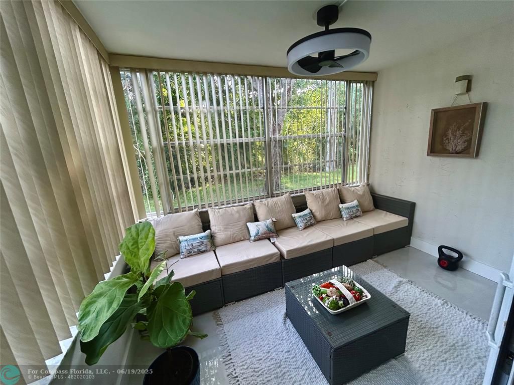 3060 Holiday Springs Boulevard, Unit 102 Margate, FL 33063 - Photo 3 of 12 a living room with furniture and a large window