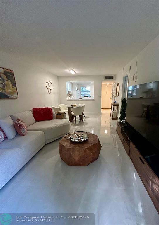 3060 Holiday Springs Boulevard, Unit 102 Margate, FL 33063 - Photo 7 of 12 a living room with furniture and a flat screen tv