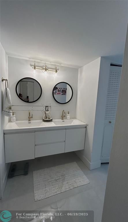 3060 Holiday Springs Boulevard, Unit 102 Margate, FL 33063 - Photo 9 of 12 a bathroom with a sink and a mirror