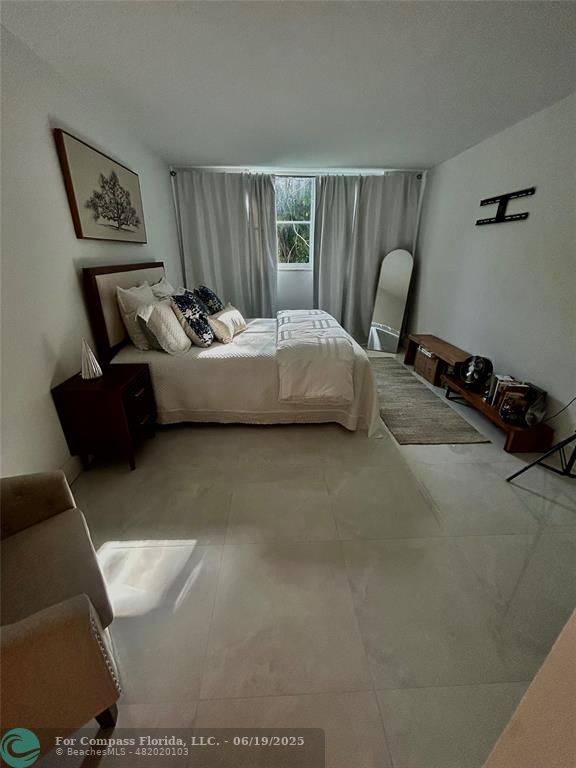 3060 Holiday Springs Boulevard, Unit 102 Margate, FL 33063 - Photo 10 of 12 a bedroom with bed and window