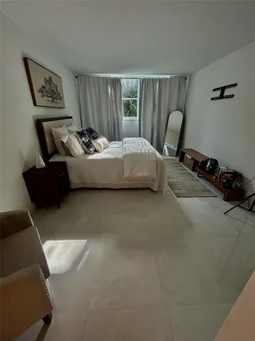 a bedroom with bed and window