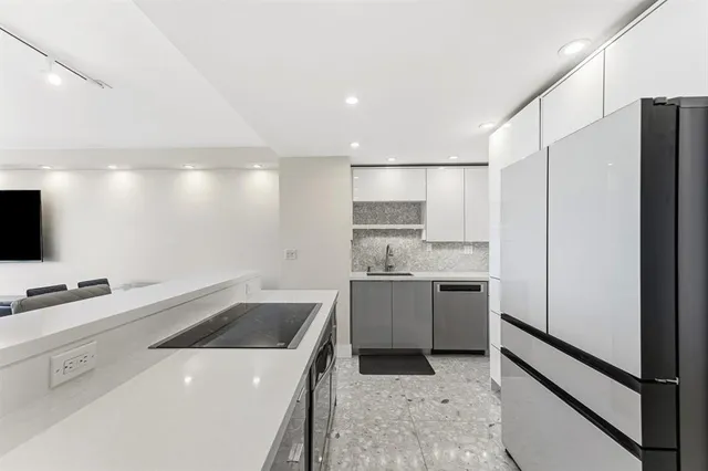 a kitchen with a sink stove and refrigerator