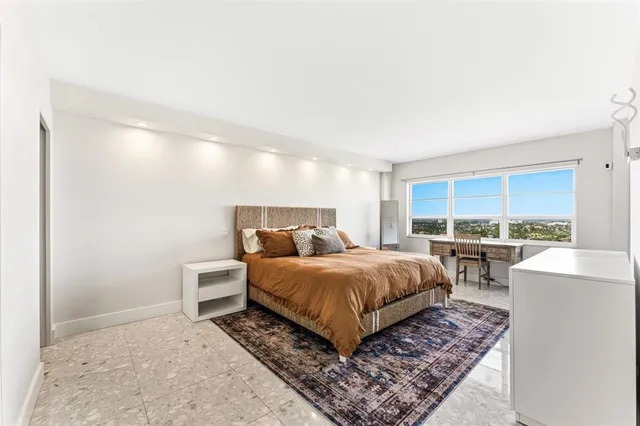 a bed room with a bed window and a table