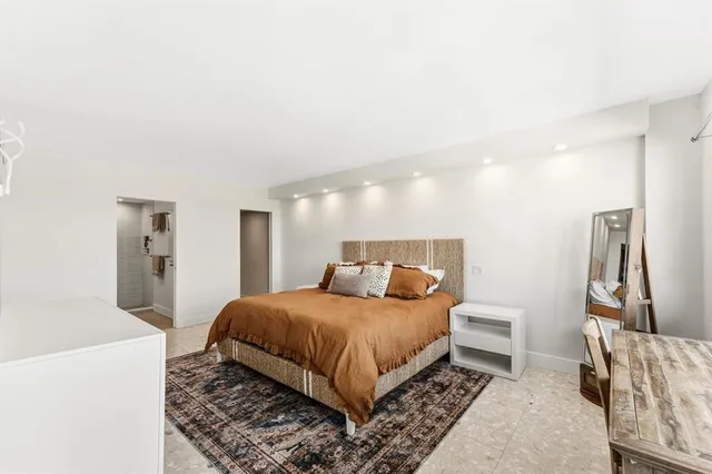 a bedroom with a bed and a couch