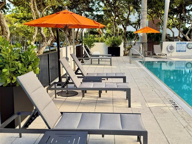 a view of house with swimming pool outdoor seating area