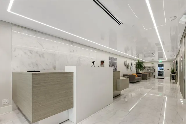 a view of livingroom with furniture and way to refrigerator