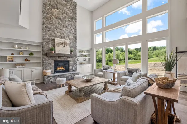 a living room with furniture fireplace and a large window