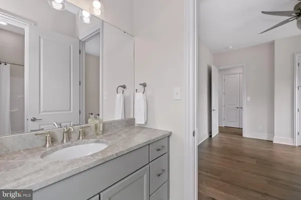 a bathroom with a granite countertop sink and a mirror