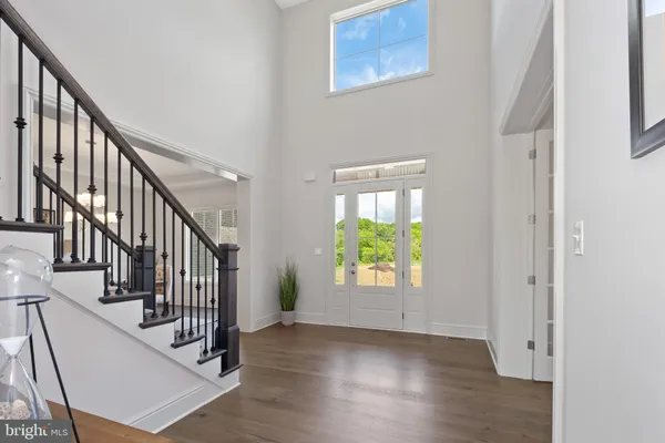 a view of staircase with railing and a window