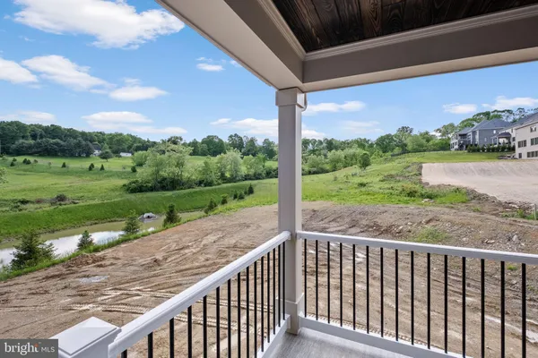 a view of a wooden deck with a yard