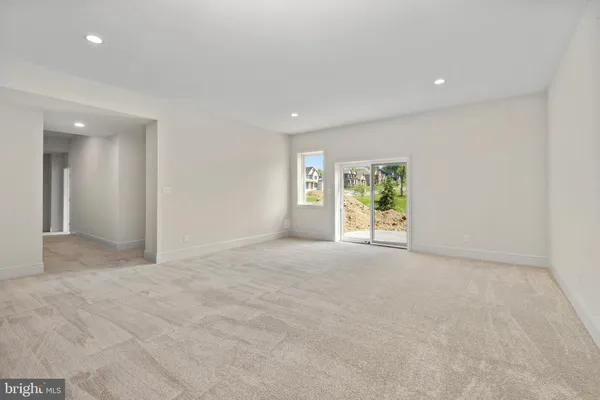 a view of a livingroom with an empty space and a window