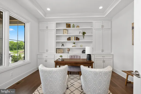 a living room with furniture a window and a bookshelf