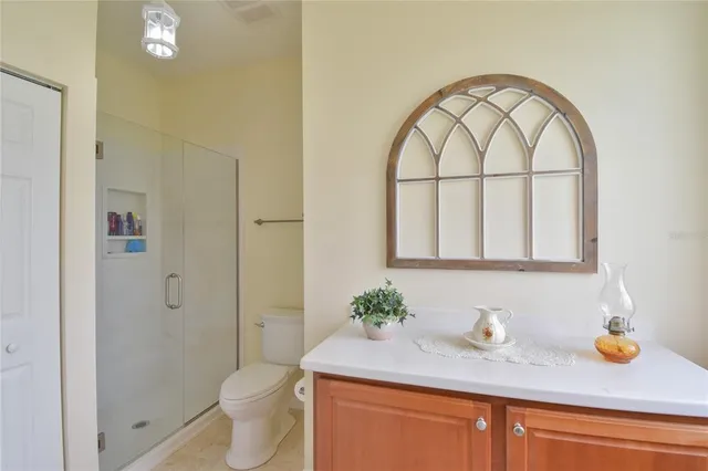 a bathroom with a granite countertop sink a toilet and a mirror