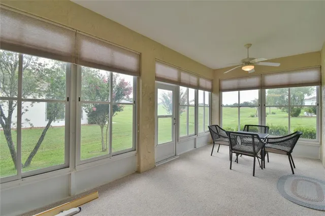 a dining room with furniture and garden view
