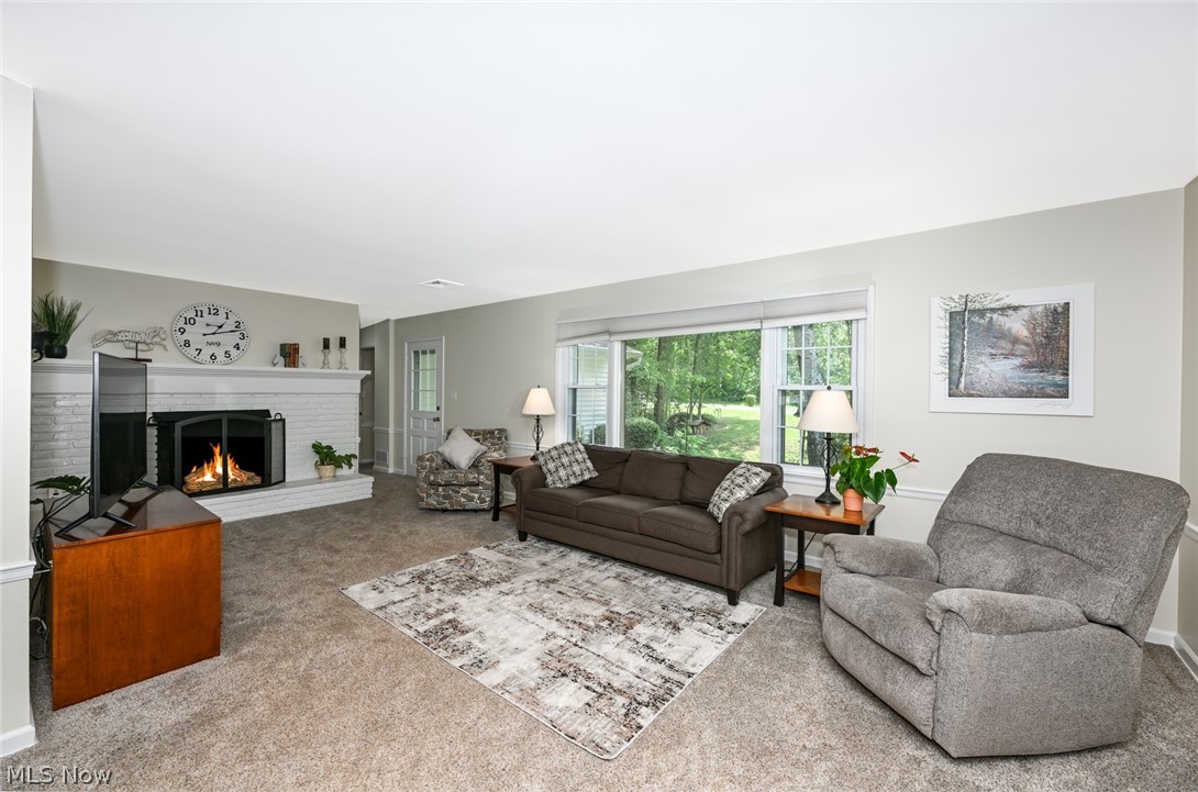 24481 Barrett Road Olmsted Falls, OH 44138 - Photo 22 of 49 Carpeted living room with a gas fireplace