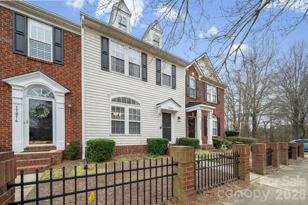 a front view of a house with a fence