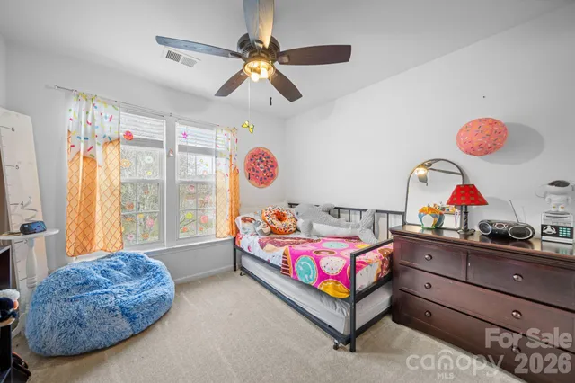 a bedroom with furniture and a window