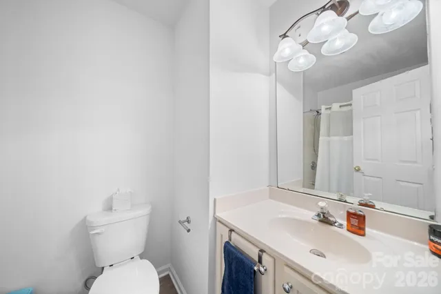 a bathroom with a sink vanity mirror and toilet