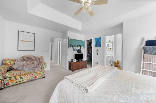 a bedroom with a bed and ceiling fan