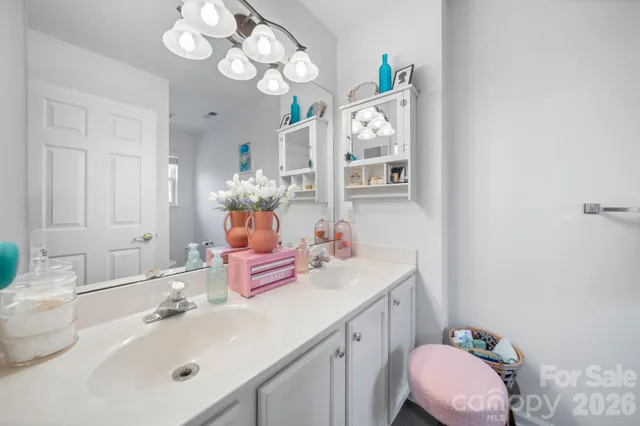 a bathroom with a sink vanity mirror and toilet