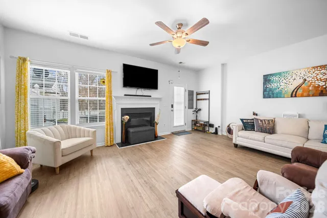 a living room with furniture fireplace and a flat screen tv