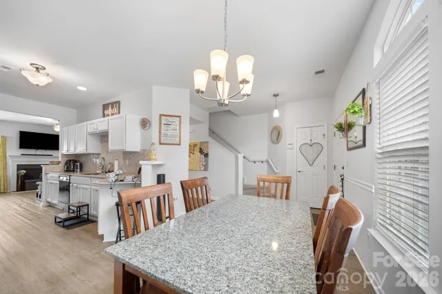 a view of a dining room with furniture and a chandelier