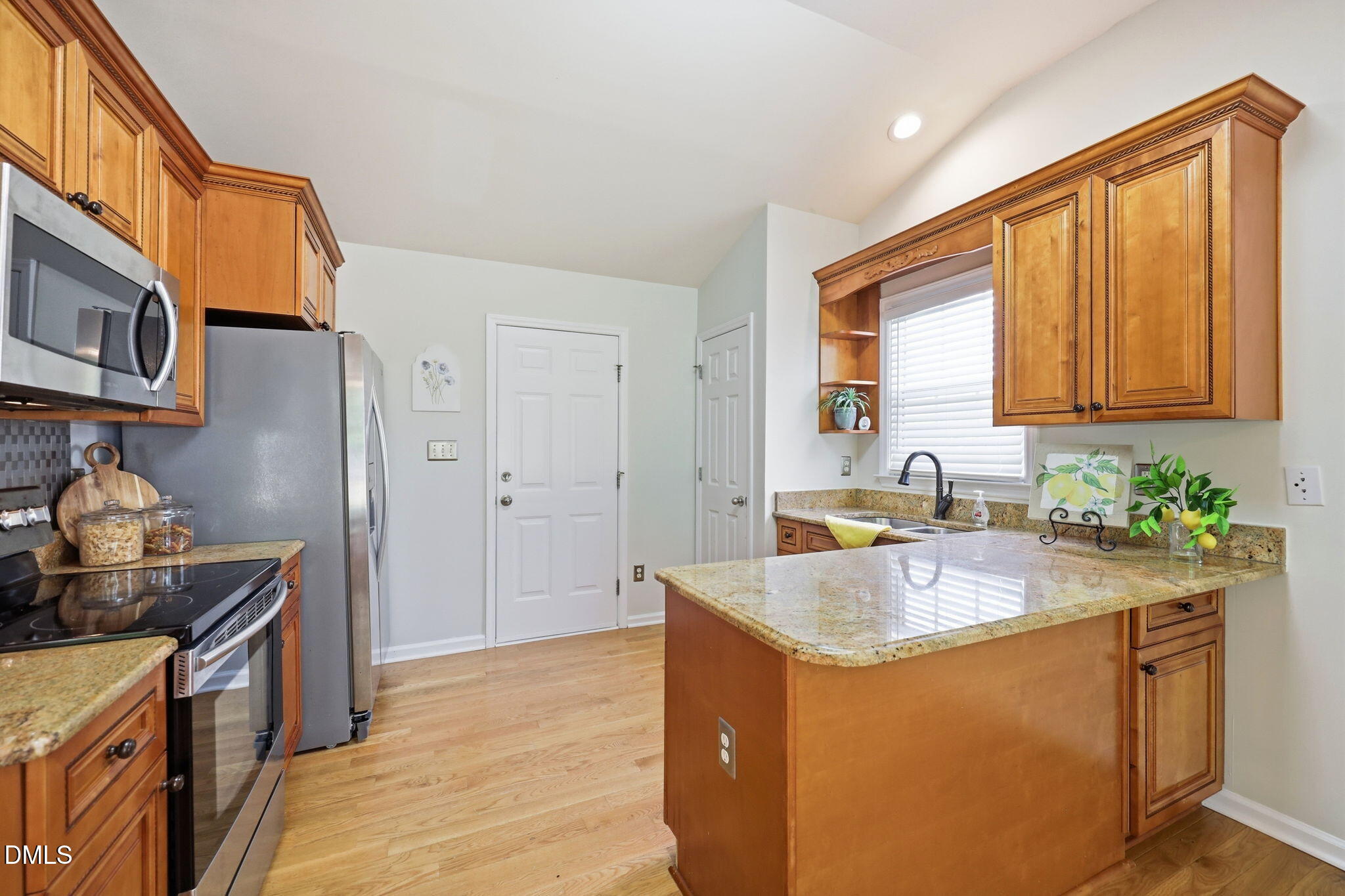 2912 Sedgefield Pines Lane Raleigh, NC 27604 - Photo 11 of 45 a kitchen with stainless steel appliances granite countertop a sink stove and refrigerator