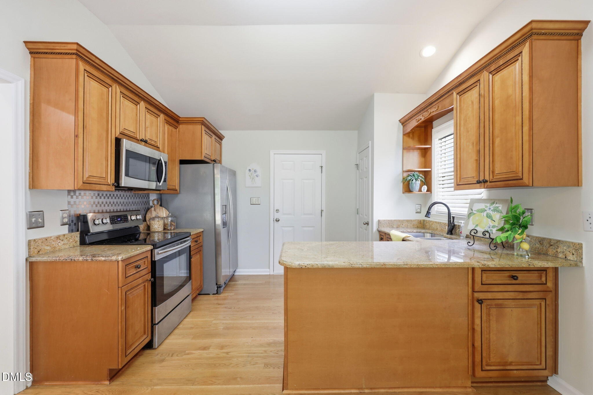 2912 Sedgefield Pines Lane Raleigh, NC 27604 - Photo 12 of 45 a kitchen with granite countertop a sink cabinets stainless steel appliances and a window
