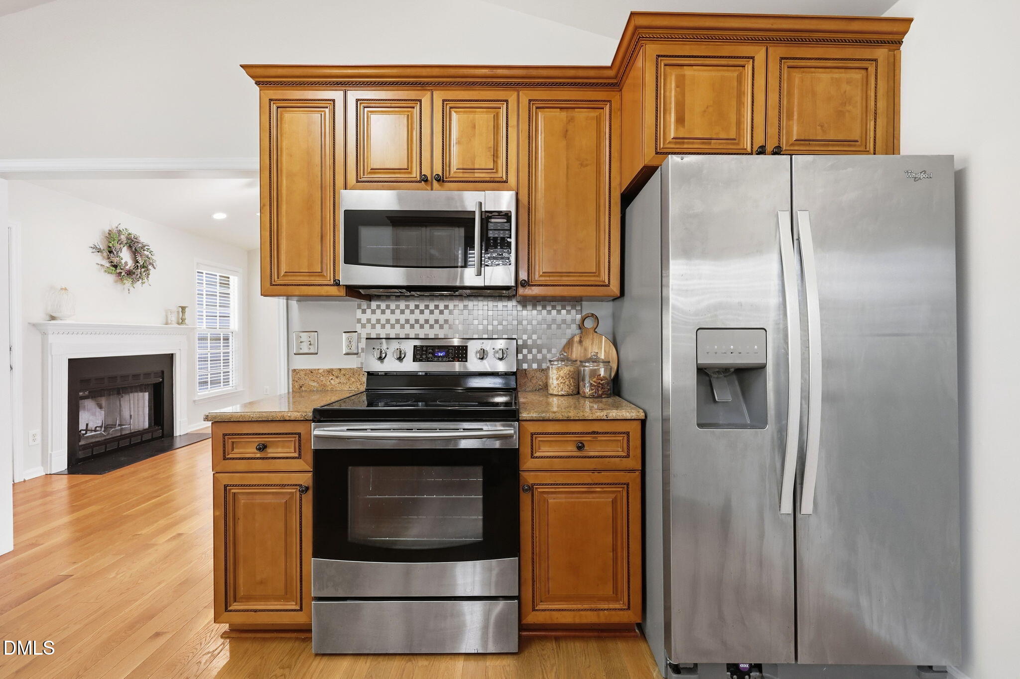2912 Sedgefield Pines Lane Raleigh, NC 27604 - Photo 13 of 45 a kitchen with granite countertop a refrigerator stove and microwave