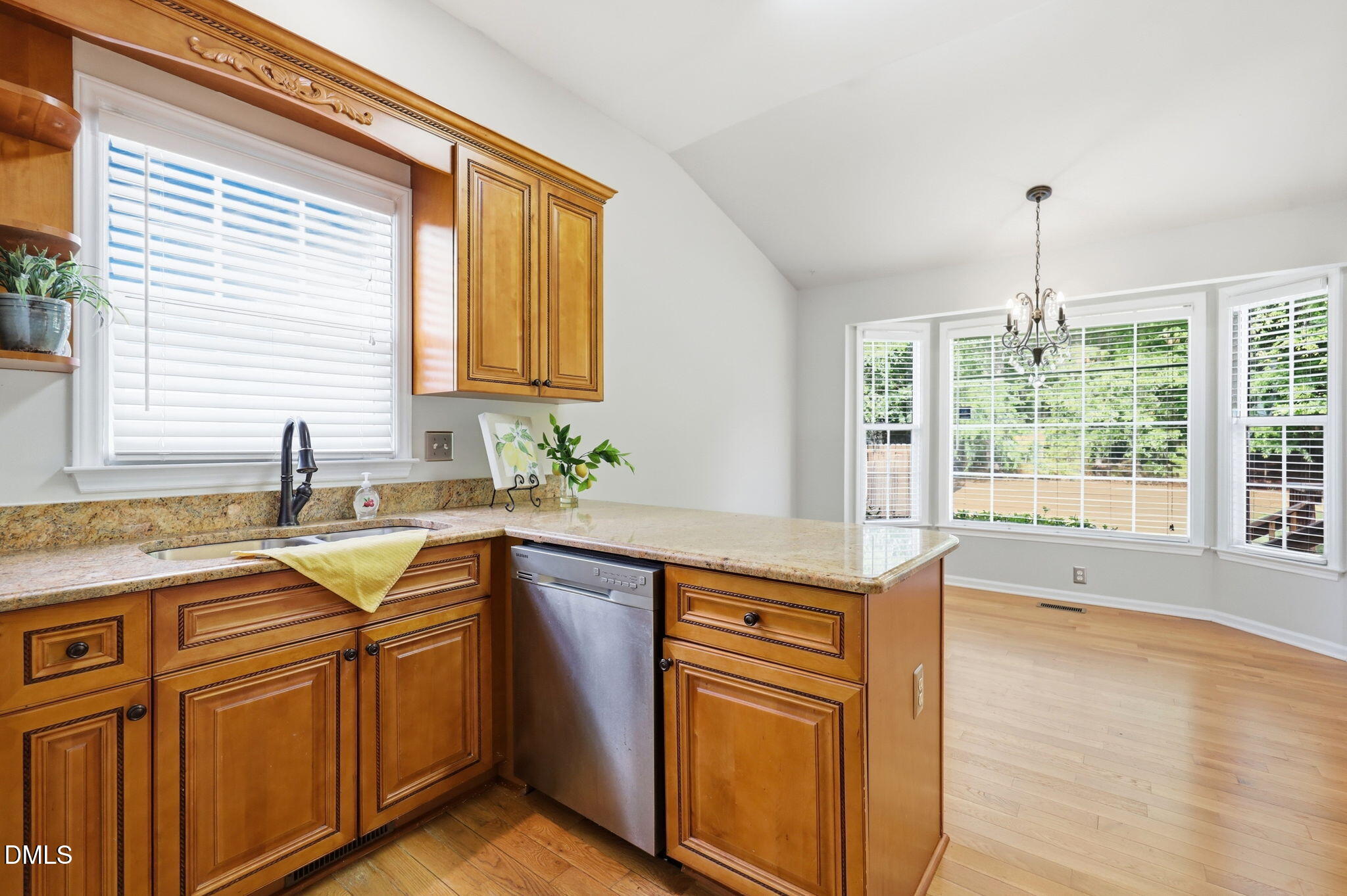2912 Sedgefield Pines Lane Raleigh, NC 27604 - Photo 14 of 45 a kitchen with stainless steel appliances granite countertop a sink and wooden cabinets