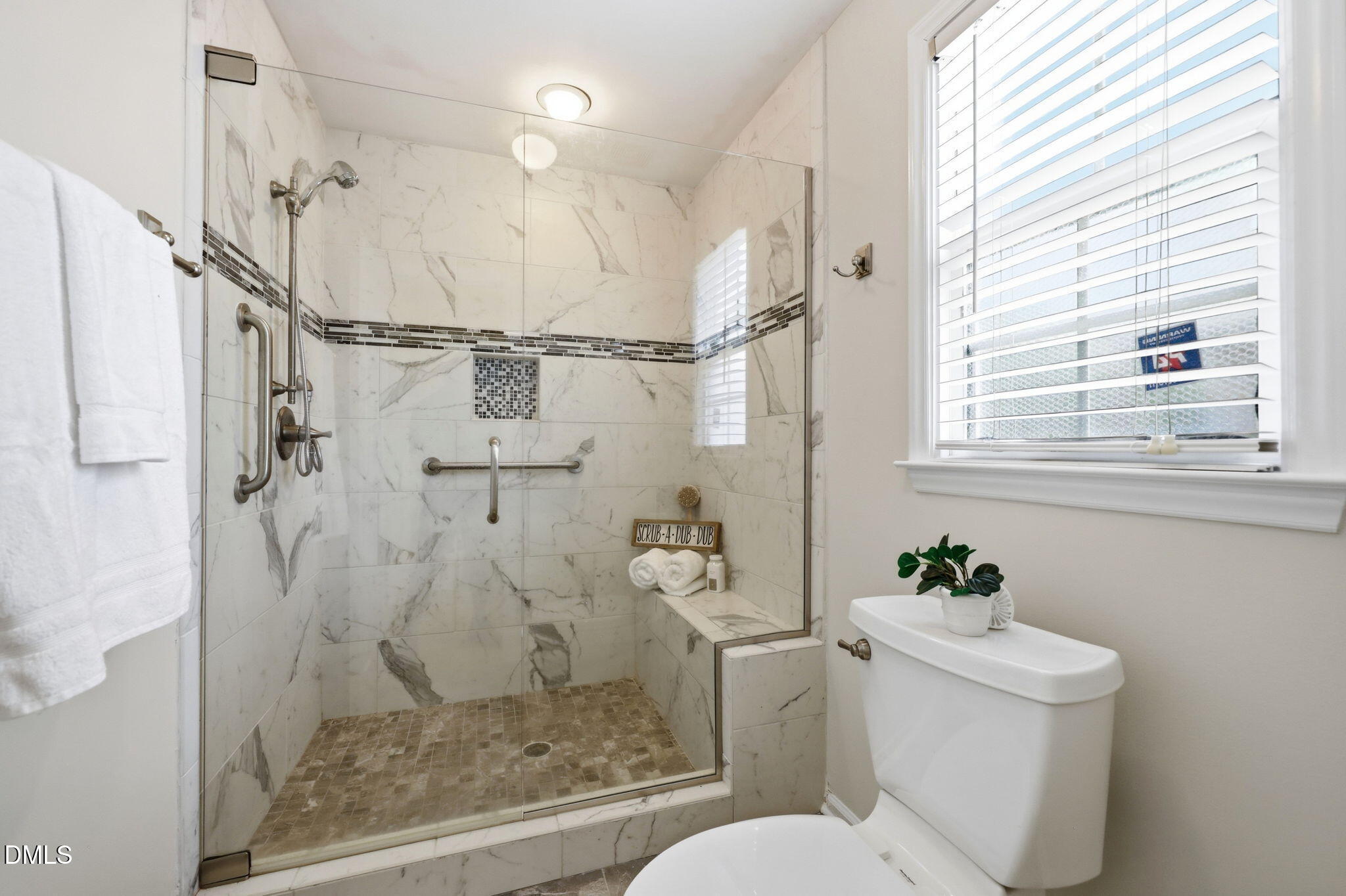 2912 Sedgefield Pines Lane Raleigh, NC 27604 - Photo 24 of 45 a bathroom with a shower toilet and a window