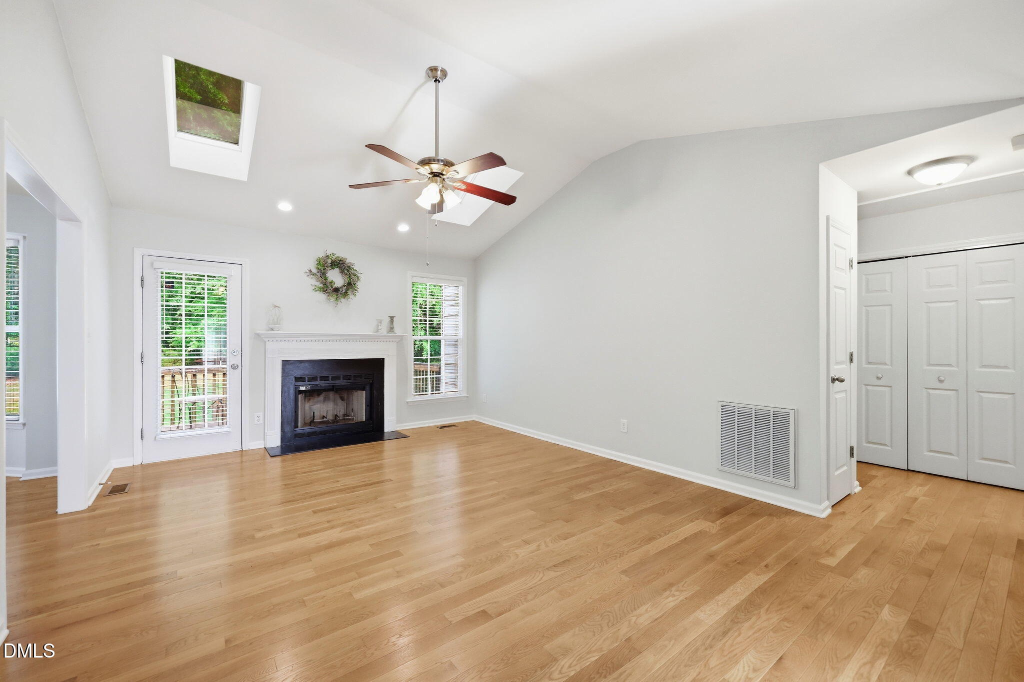 2912 Sedgefield Pines Lane Raleigh, NC 27604 - Photo 7 of 45 a view of an empty room with a fireplace and a window