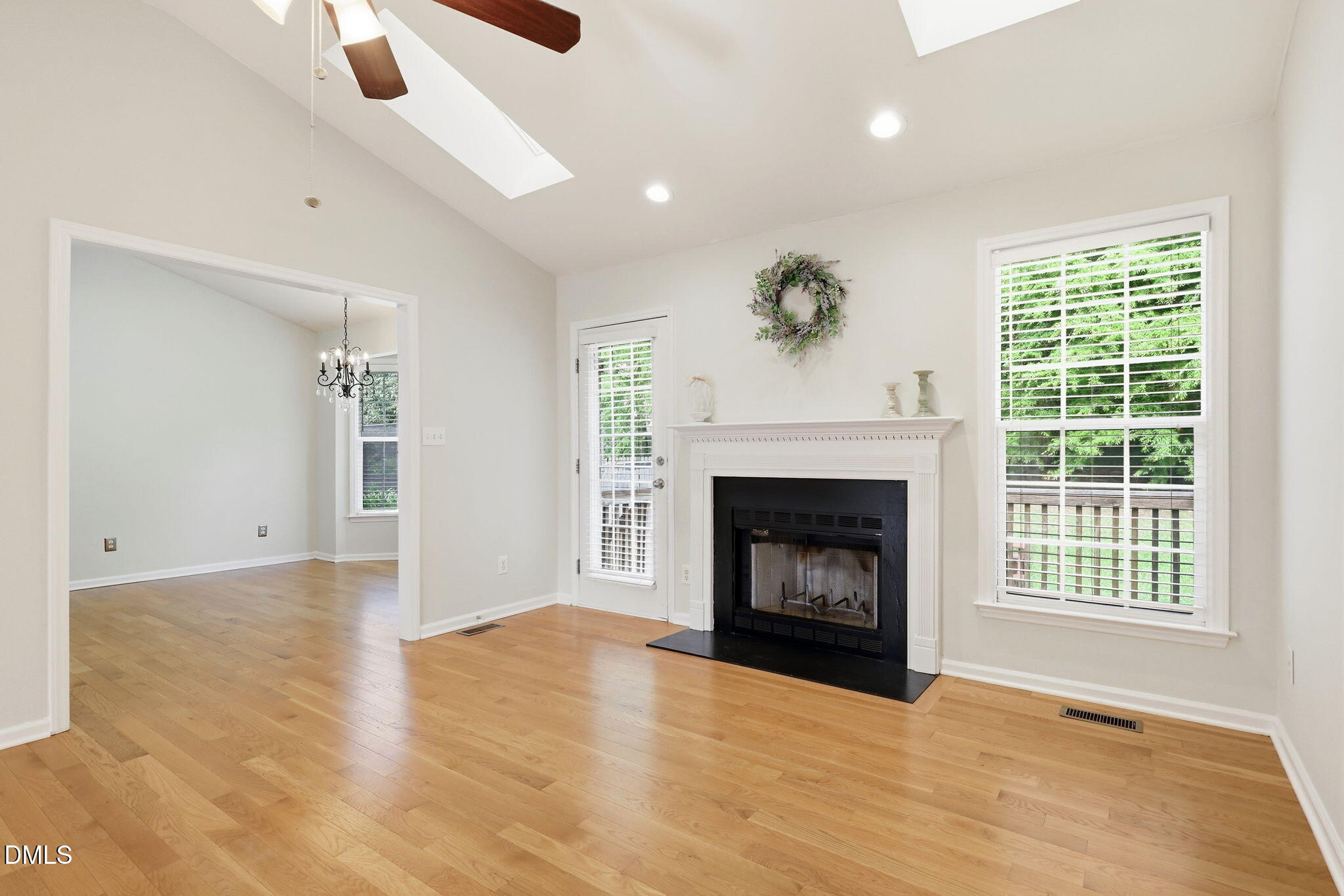 2912 Sedgefield Pines Lane Raleigh, NC 27604 - Photo 8 of 45 a view of an empty room with wooden floor fireplace and a window