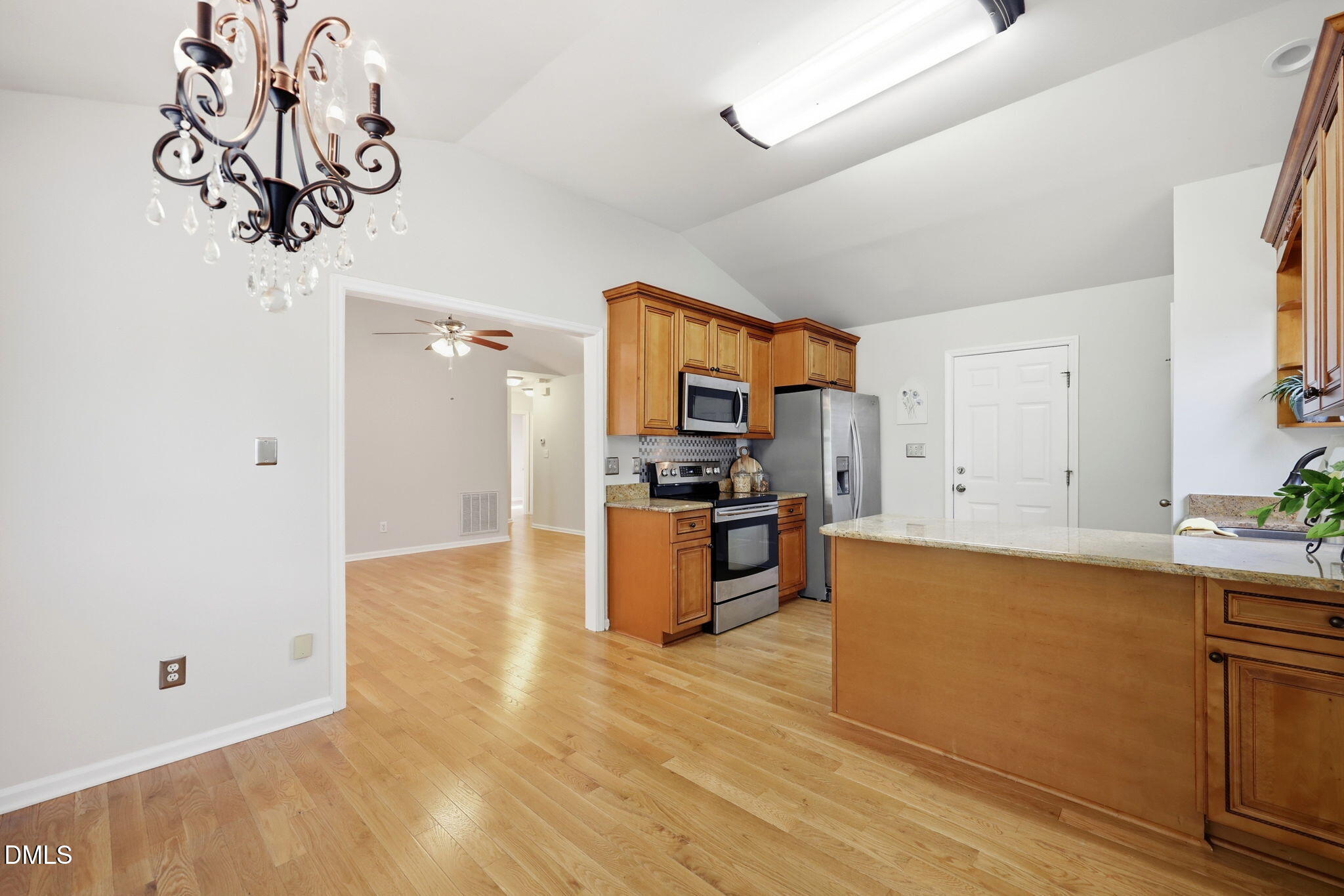 2912 Sedgefield Pines Lane Raleigh, NC 27604 - Photo 10 of 45 a kitchen with granite countertop a refrigerator and a sink