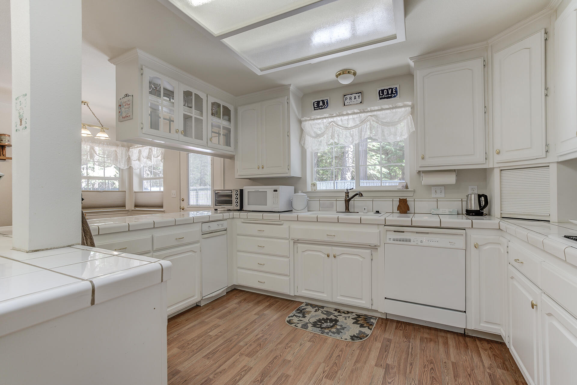 8303 Amberwoods Place Shingletown, CA 96088 - Photo 18 of 58 a kitchen with a sink cabinets and window