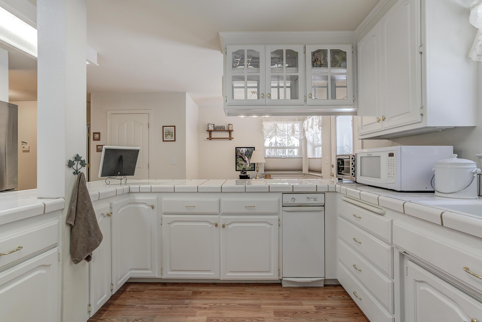 8303 Amberwoods Place Shingletown, CA 96088 - Photo 21 of 58 a kitchen with stainless steel appliances white cabinets and a sink