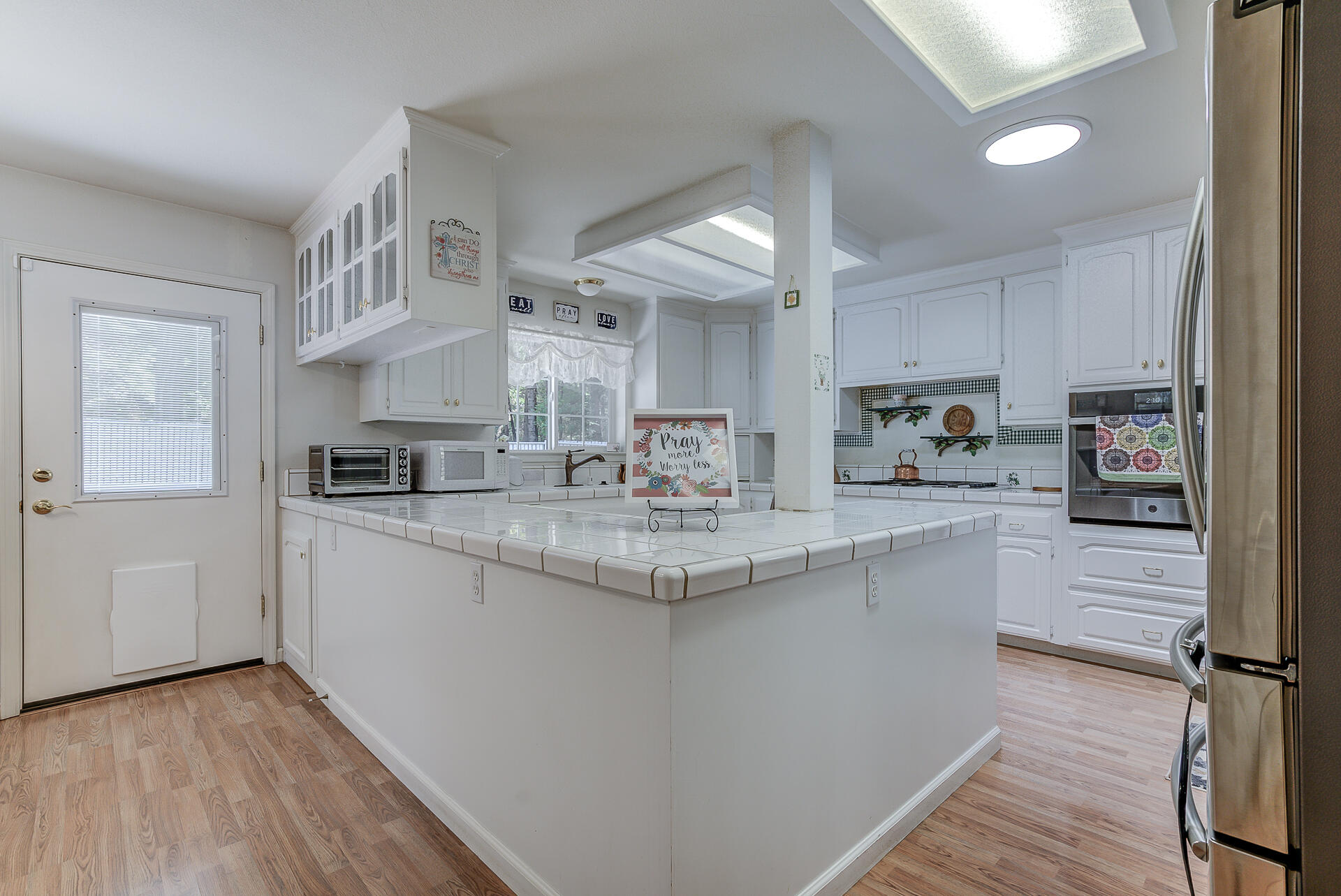 8303 Amberwoods Place Shingletown, CA 96088 - Photo 24 of 58 a kitchen with counter top space and cabinets
