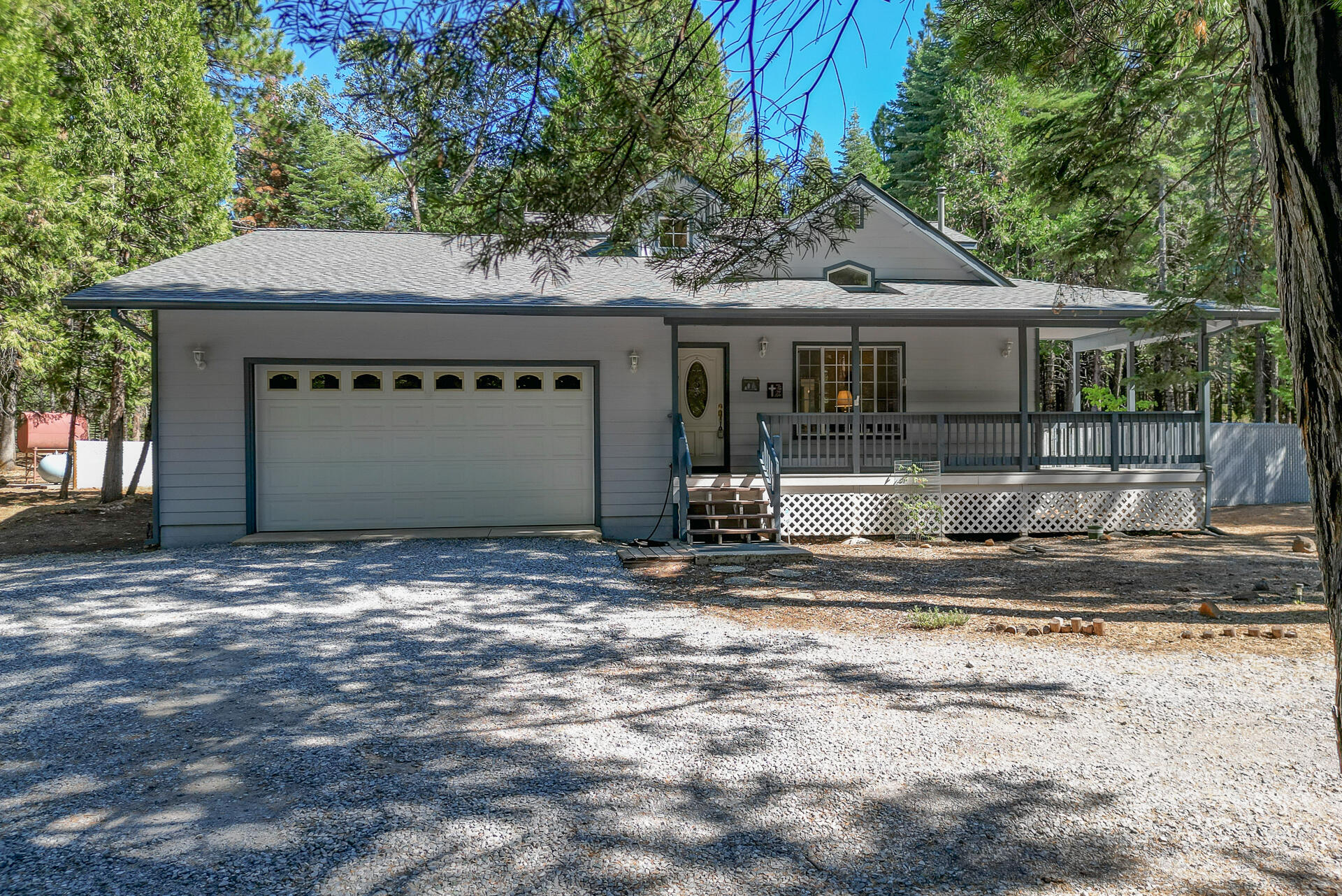 8303 Amberwoods Place Shingletown, CA 96088 - Photo 3 of 58 a front view of a house with garden
