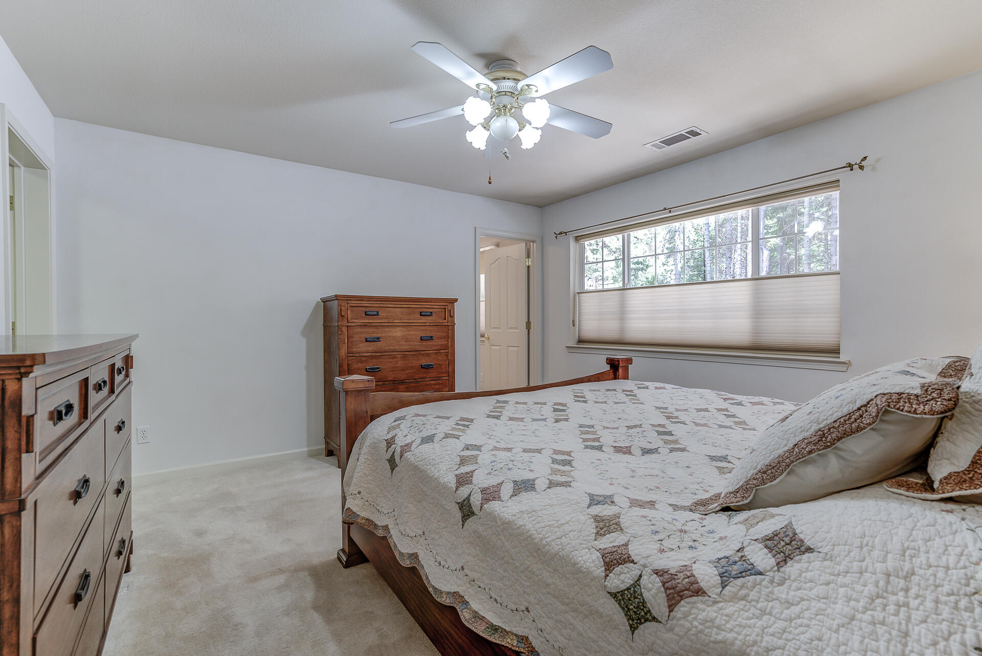 8303 Amberwoods Place Shingletown, CA 96088 - Photo 31 of 58 a bedroom with a bed and a window