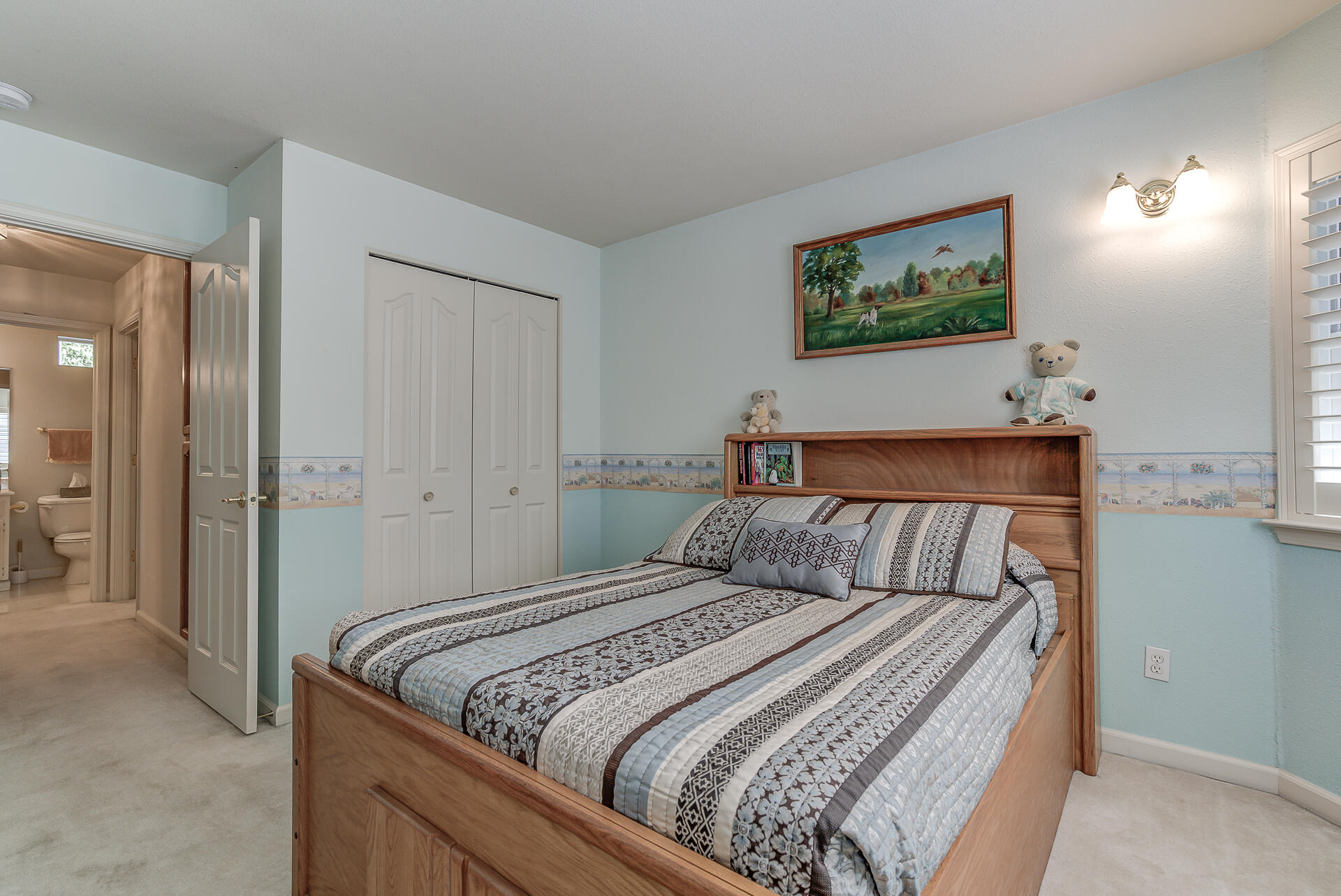 8303 Amberwoods Place Shingletown, CA 96088 - Photo 42 of 58 a bedroom with a bed and a painting on the wall