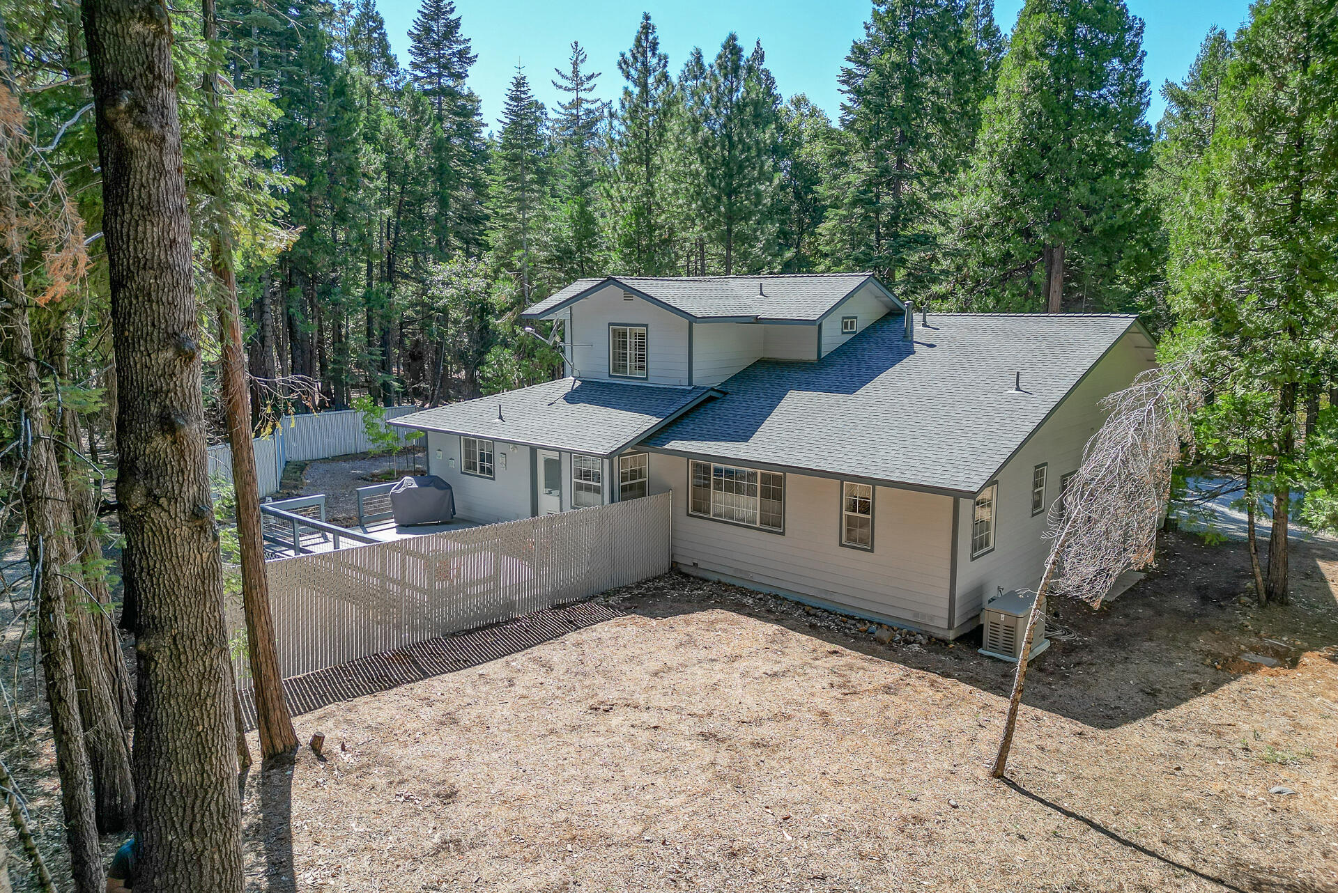 8303 Amberwoods Place Shingletown, CA 96088 - Photo 47 of 58 a view of a house with a tub and trees in the background