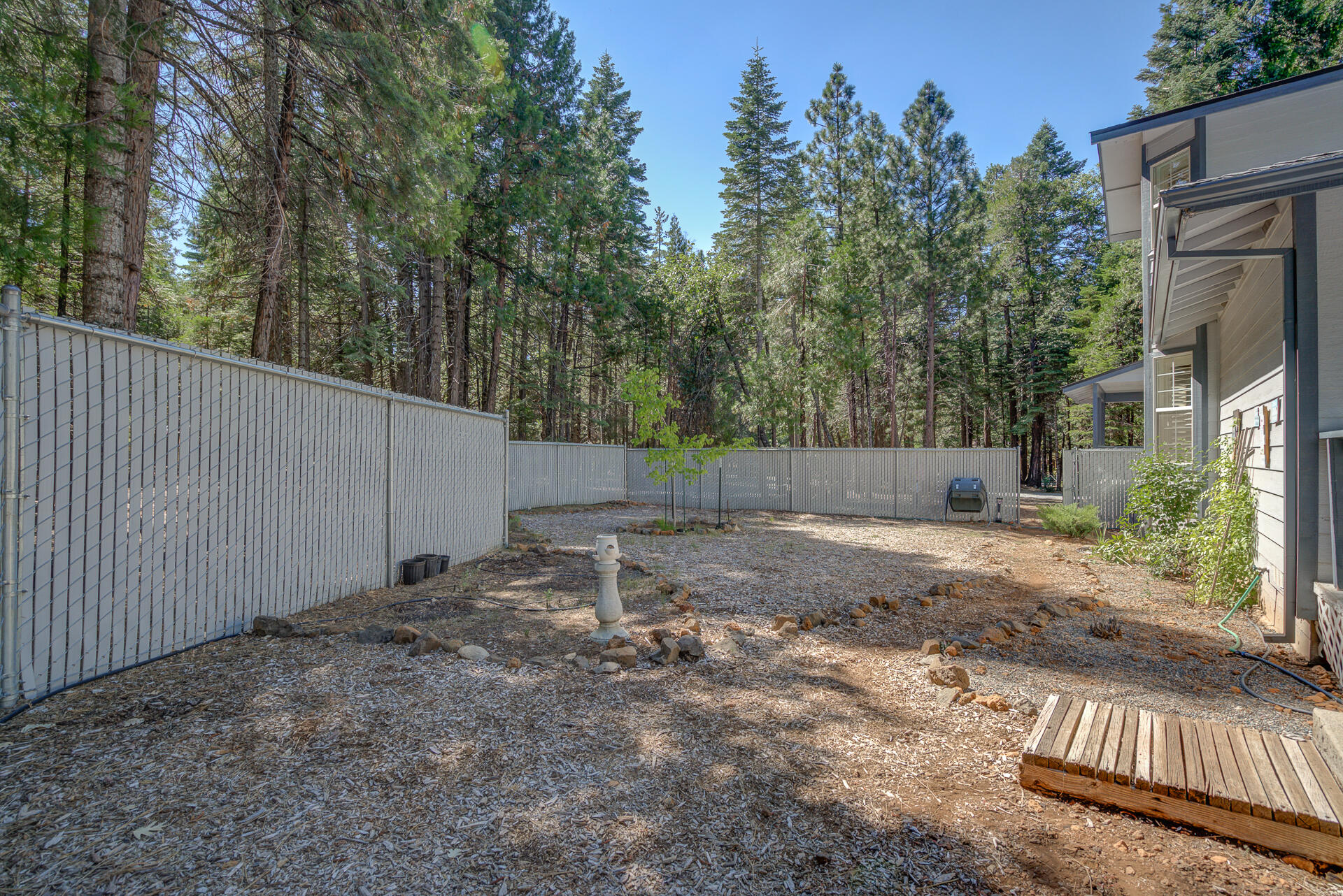 8303 Amberwoods Place Shingletown, CA 96088 - Photo 52 of 58 a backyard of a house with lots of green space