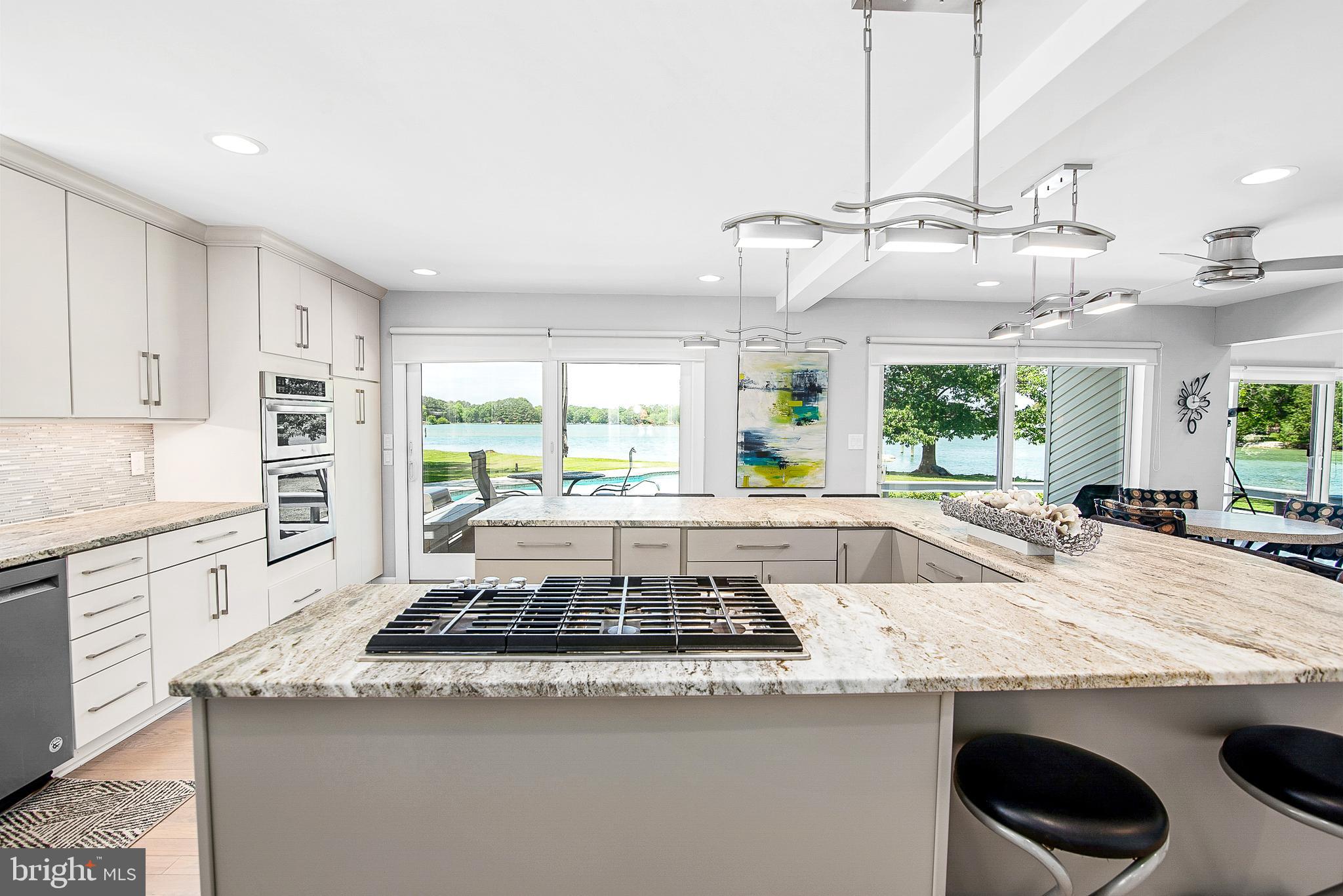 26282 Deep Water Harbor Road Easton, MD 21601 - Photo 16 of 53 a kitchen with stainless steel appliances granite countertop a sink and a stove