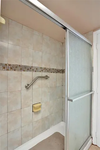 a bathroom with a glass shower door