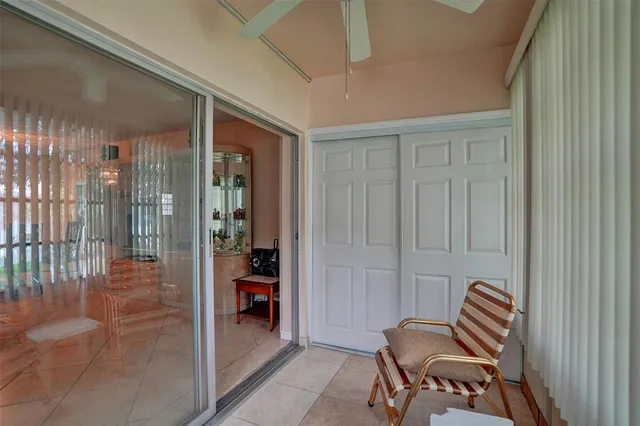 a view of a hallway with chairs and a bathroom
