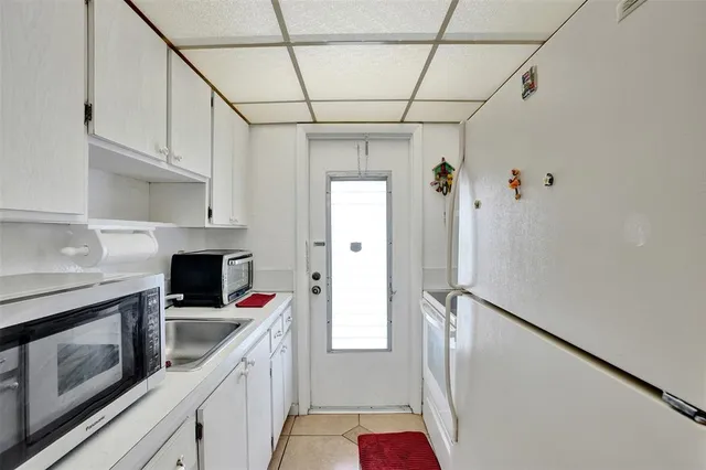 a kitchen with stainless steel appliances a stove refrigerator and cabinets