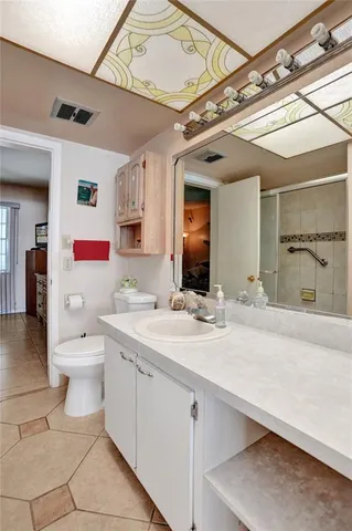 a spacious bathroom with a granite countertop sink mirror and toilet