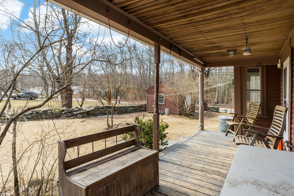 1067 Middle Street Dighton, MA 02764 - Photo 38 of 42 a balcony with wooden floor and outdoor seating