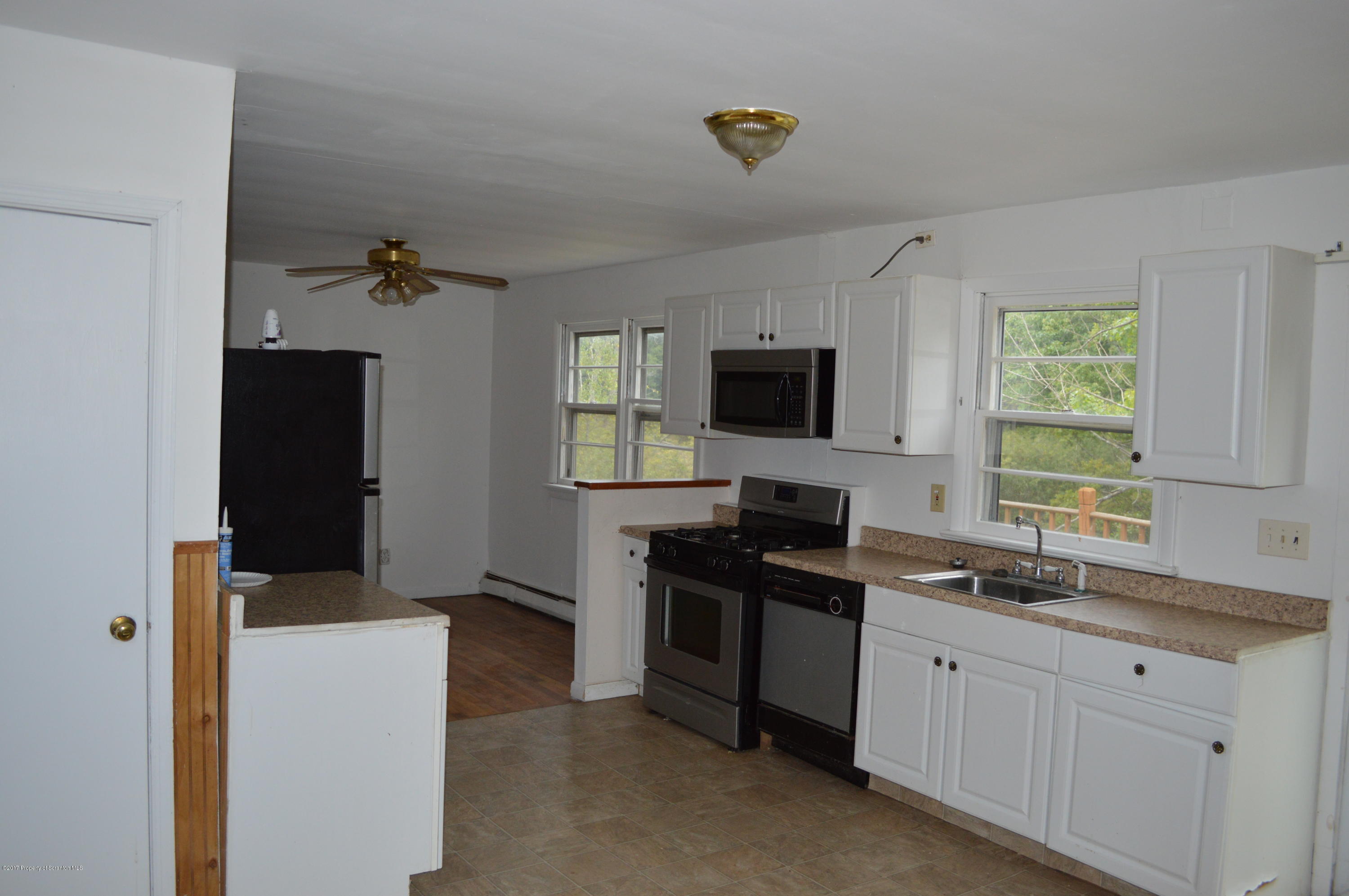 1063 Mt Cobb Road Lake Ariel, PA 18436 - Photo 7 of 20 a kitchen with a sink and a stove top oven