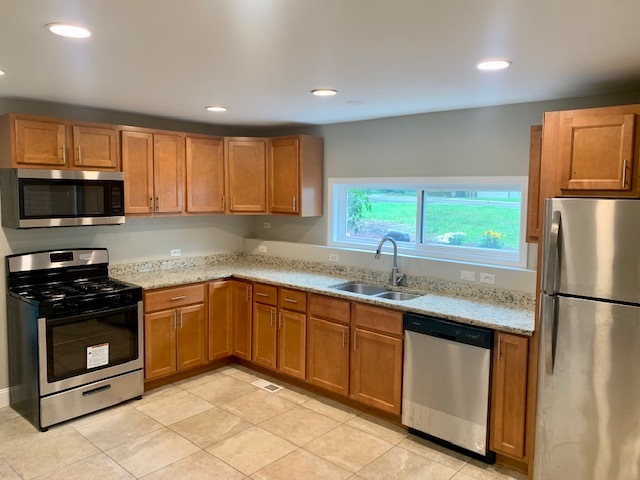 17 Timber Trail Streamwood, IL 60107 - Photo 3 of 10 a kitchen with stainless steel appliances granite countertop a refrigerator sink and stove